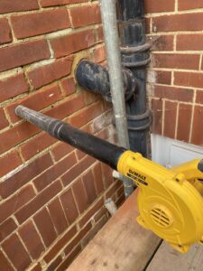 Clear debris from wall tie hole