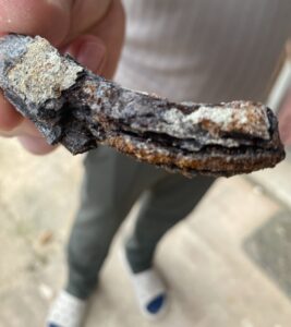 Severely corroded wall tie removed from a Folkestone property, showing thick layers of rust and flaking.